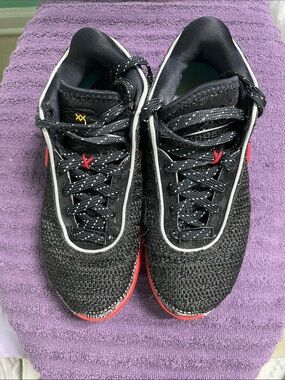 Nike Black Knit Sneakers with Gold Swoosh and Red Accents